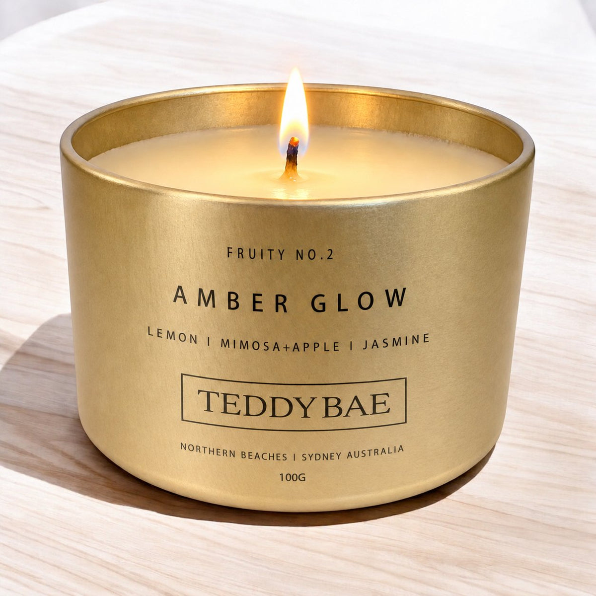 Lit Teddybae amber glow travel tin candle
